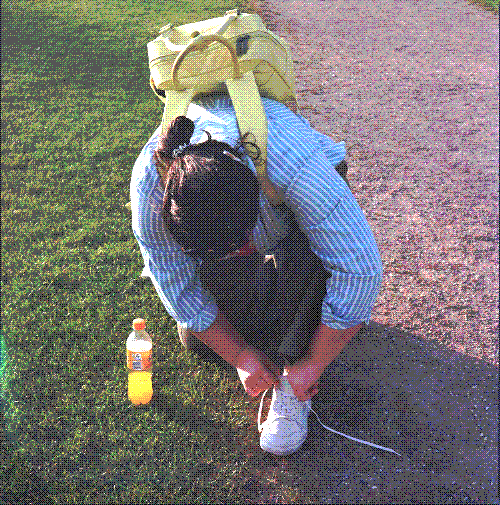 Lucy bent over her shoe to tie it